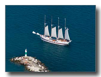Boat passing lighthouse